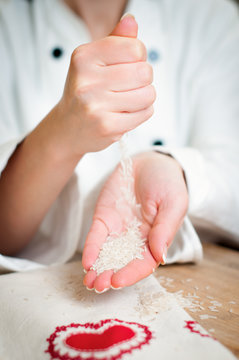 hands pouring rice