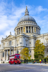 St. Paul's Cathedral and red doubledeckers with tourists, UK