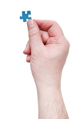 male hand with jigsaw puzzle piece