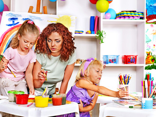 Child painting at easel.