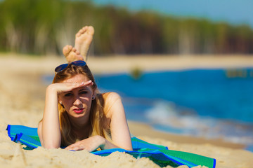 Summer vacation Girl in bikini sunbathing on beach