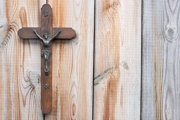 Wooden cross on wooden background