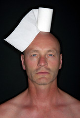 man with toilet paper on his head