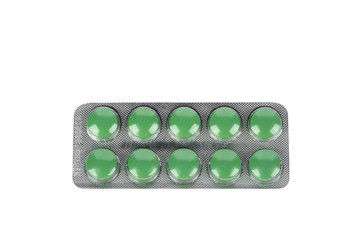 Green pills in blisters on white background