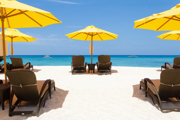 Yellow sun umbrellas and beach chairs