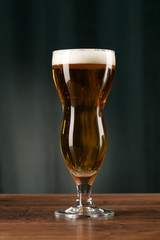Glass beer on wood background with copyspace