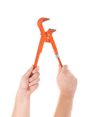 Pipe wrench in humam hands.