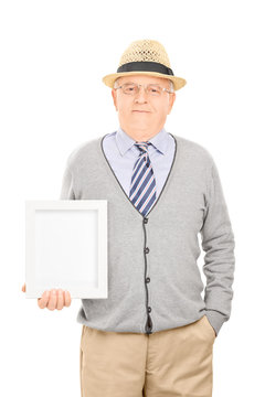 Senior Gentleman Holding A Picture Frame