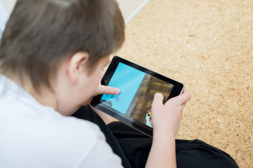 Boy playing on a Tablet PC