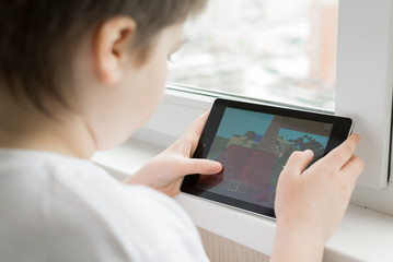 Boy playing on a Tablet PC