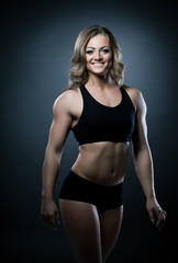 Young athletic woman body builder portrait