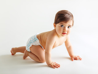 Cute baby girl in diapers crawling. © BalanceFormCreative