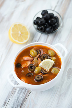 Solyanka soup made of various meat, vegetables, olives and lemon