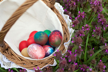 wicker basket with colorful easter eggs