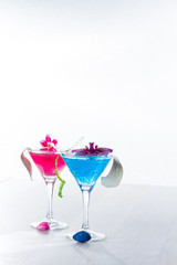 Blue swimming pool Cocktail with caviar and flower petals