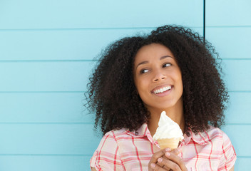 Smiling young woman enjoying ice cream