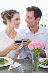 Loving couple with wine glasses looking at each other