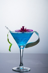 Blue swimming pool Cocktail with caviar and flower petals