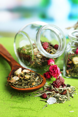 Obraz na płótnie Canvas Assortment of herbs and tea in glass jars