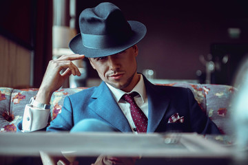 businessman in a hat in a restaurant