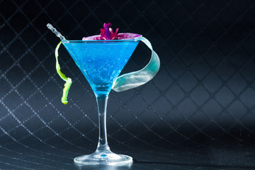 Blue swimming pool Cocktail with caviar and flower petals