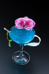 Blue swimming pool Cocktail with caviar and flower petals