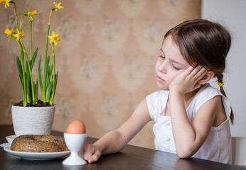 Thoughtful preschooler girl refusing to eat