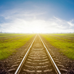 Fototapeta na wymiar railway leawing far to a sunrise