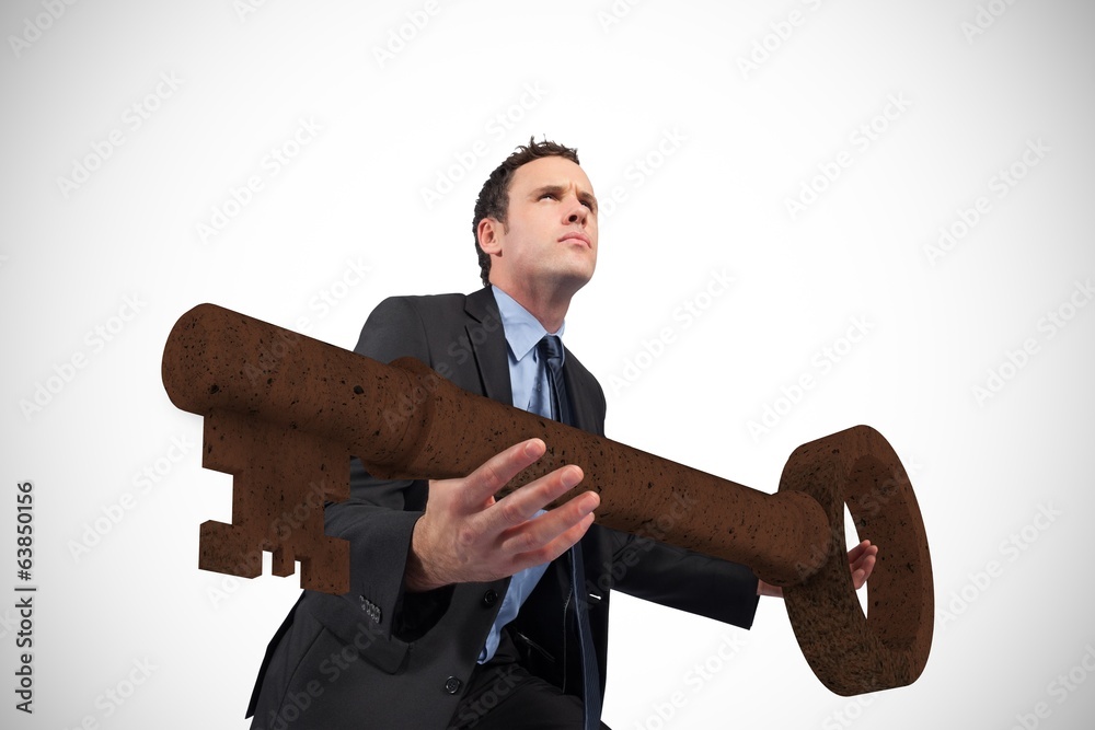 Poster composite image of businessman carrying large key