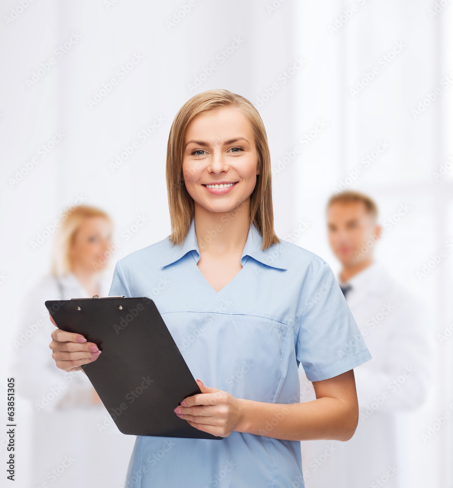 Wall mural smiling female doctor or nurse with clipboard