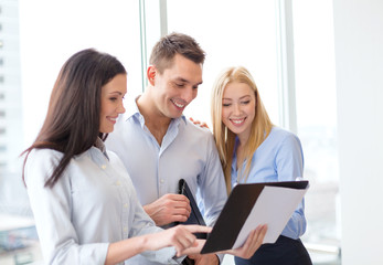 business team looking at clipboard