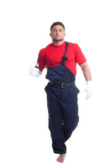Handsome young man taking off his overalls