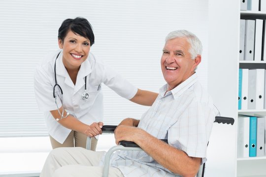 Female doctor with senior patient in wheelchair