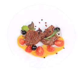 Beef steaks with rosemary and tomatoes.