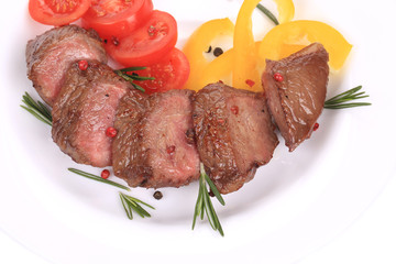 Beefsteaks with tomatoes and rosemary.