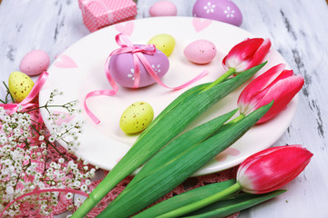 Easter table setting with tulips and eggs