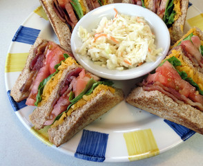 Toasted bacon, lettuce, tomato and cheese clubhouse sandwich, served with coleslaw.