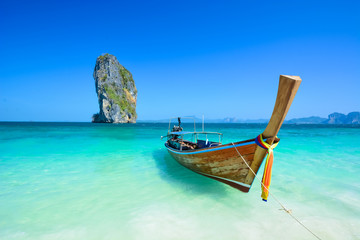 Cliff and boat in the amazing beach in tropical island in Krabi, Phuket, Thailand - obrazy, fototapety, plakaty