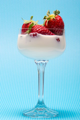 fresh strawberries on a glass with cream