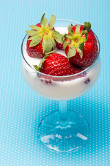 fresh strawberries on a glass with cream