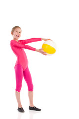 Little gymnastics girl posing with a ball.