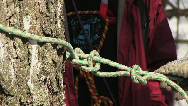 Man tying a knot in a climbing rope