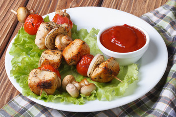 two grilled chicken kebab with mushrooms on a plate