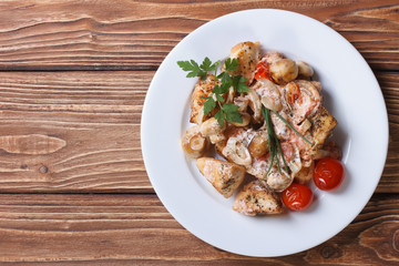 stew chicken with mushrooms on a white plate  top view