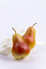 Two pears on white background and ribbon