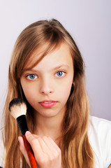 portrait of teenager girl doing makeup