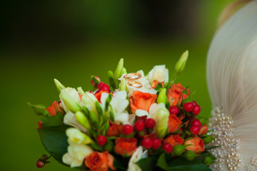 Red wedding bouquet with rings