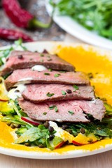Salad with grilled beef steak, black lentils, rocket, radish