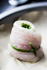 Cooking rolls of white fish fillet stuffed with herbs