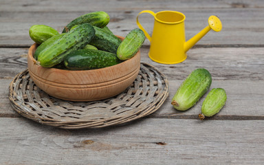 Cucumbers in a wooden bowl  on an old wooden table